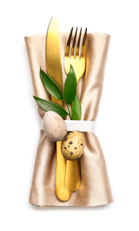 Stylish cutlery for Easter celebration on white background