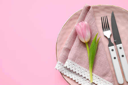 Elegant table setting and flower on pink backgroundの写真素材