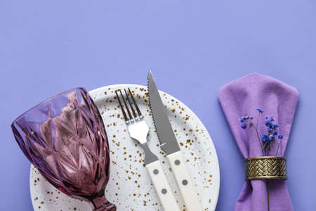 Simple table setting with flowers on purple backgroundの写真素材