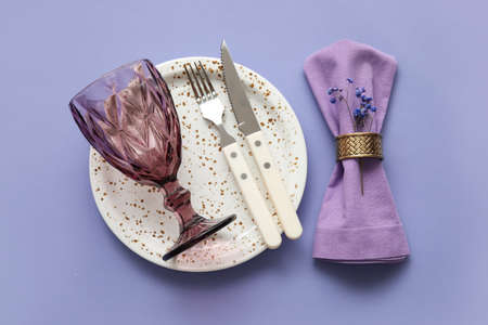 Simple table setting with flowers on purple backgroundの写真素材