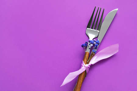 Simple table setting with flowers on purple backgroundの写真素材