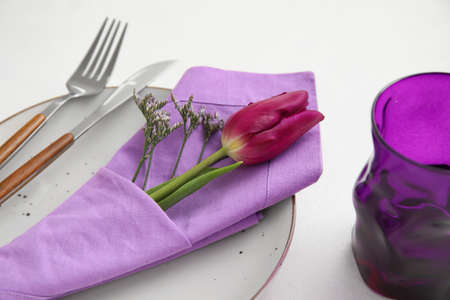 Simple table setting with flowers on white background, closeupの写真素材