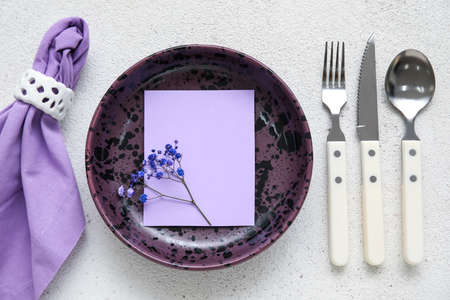 Simple beautiful table setting with flowers on light backgroundの写真素材