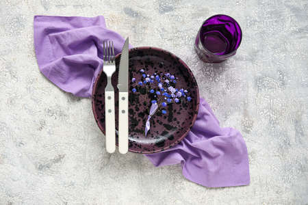 Simple beautiful table setting with flowers on light backgroundの写真素材