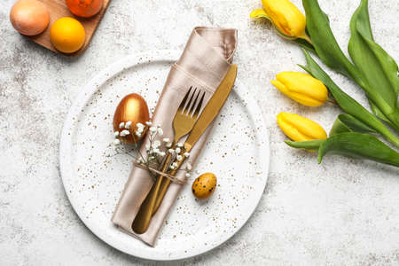 Stylish Easter table setting on light background
