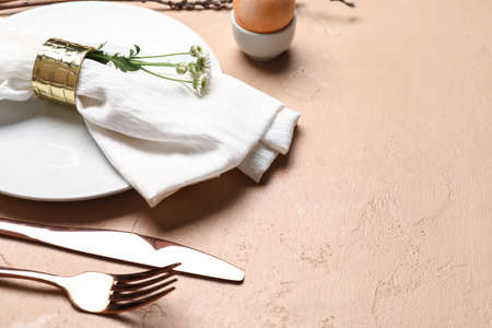 Stylish Easter table setting on beige background
