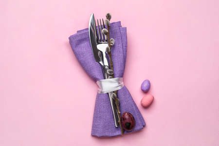 Stylish Easter cutlery on pink background
