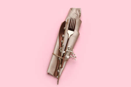 Stylish Easter cutlery on pink backgroundの写真素材