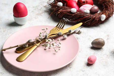 Stylish Easter table setting on light background