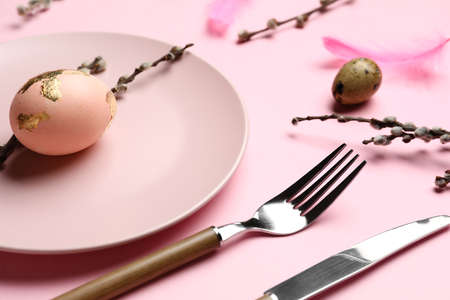 Stylish Easter table setting on pink backgroundの写真素材