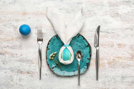 Stylish Easter table setting on light background