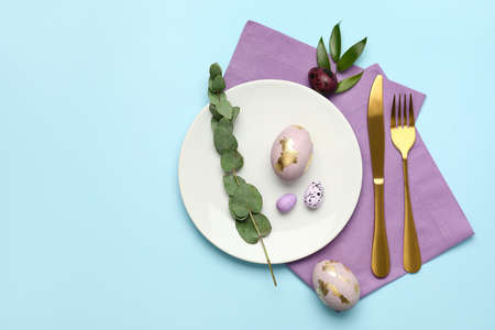 Stylish Easter table setting on blue backgroundの写真素材