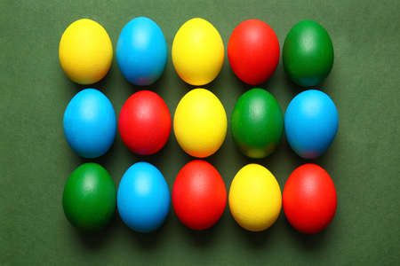 Multicolored Easter eggs on color background