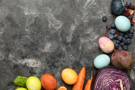Composition with beautiful Easter eggs and natural dyes on grunge background
