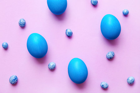 Blue painted Easter eggs on color backgroundの写真素材