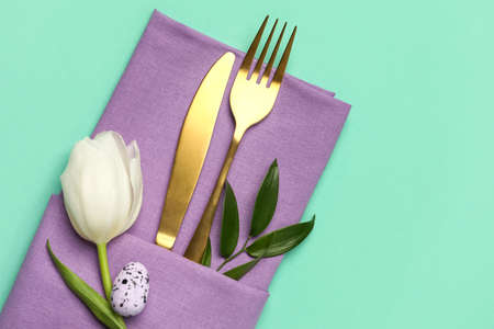 Stylish Easter cutlery on green backgroundの写真素材