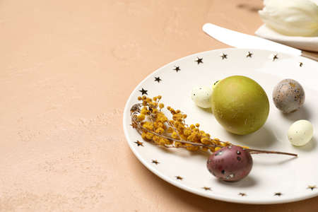 Stylish Easter table setting on beige background