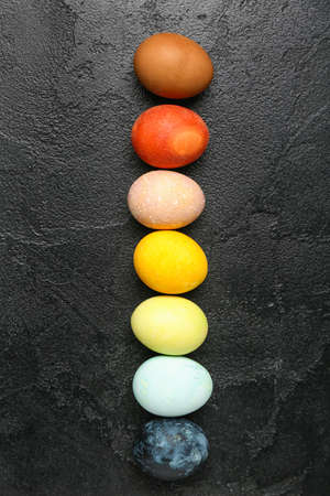 Multicolored Easter eggs on dark background