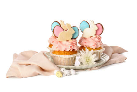 Plate with tasty Easter cupcakes and eggs on white background
