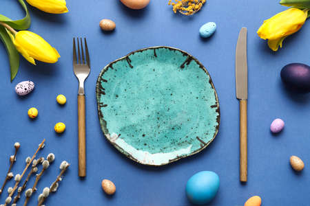 Beautiful table setting for Easter celebration on blue background