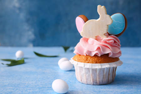 Tasty Easter cupcake and eggs on blue background, closeupの写真素材