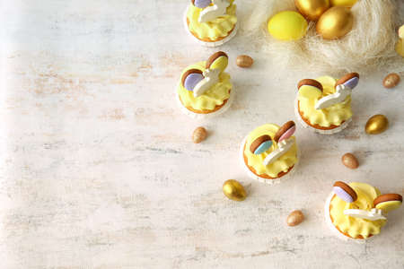 Tasty Easter cupcakes with eggs on light backgroundの写真素材