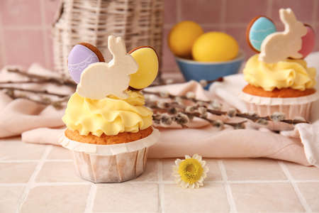Tasty Easter cupcake and willow branches on color background, closeupの写真素材
