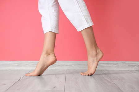 Bare feet near pink wall