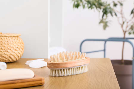 Body massage brush on wooden table in bathroomの写真素材