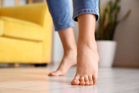 Woman with bare feet at home, closeupの写真素材