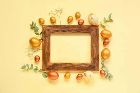 Composition with frame, Easter eggs and flowers on beige background