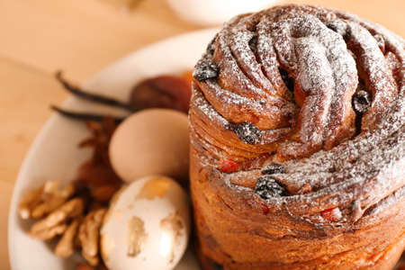 Plate with delicious Easter cake and eggs on table, closeup