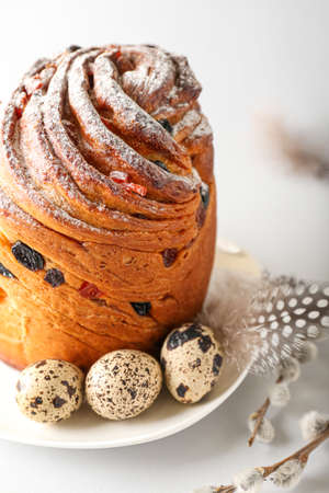 Plate with delicious Easter cake and eggs on light background, closeup