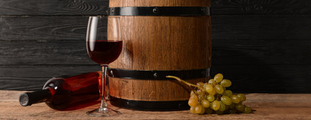 Barrel, bottle and glass of wine on wooden backgroundの写真素材