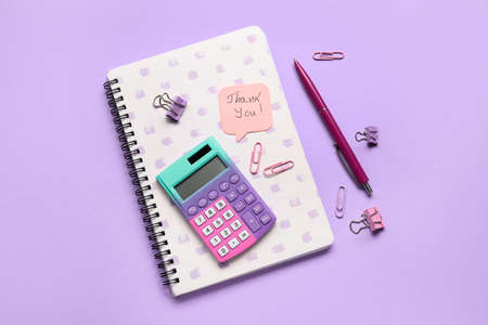 Sticky note with text THANK YOU and stationery on lilac background