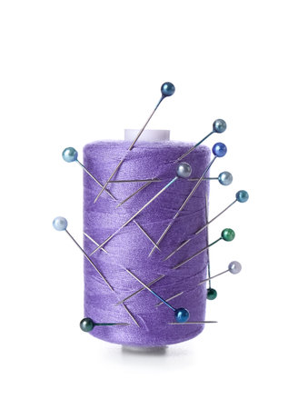Purple thread spool with ball pins on white backgroundの写真素材