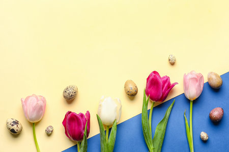 Composition with Easter eggs and flowers on color backgroundの写真素材