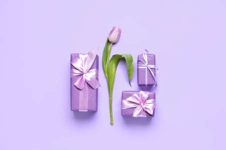 Gift boxes and tulips on color backgroundの写真素材