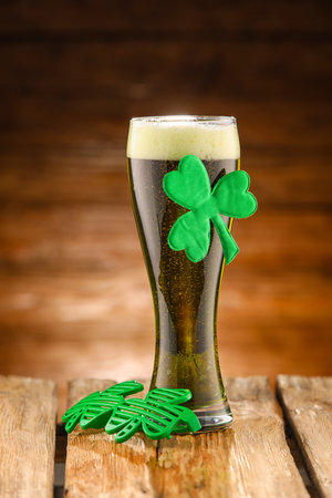 Glass of beer on wooden background. St. Patrick's Day celebration