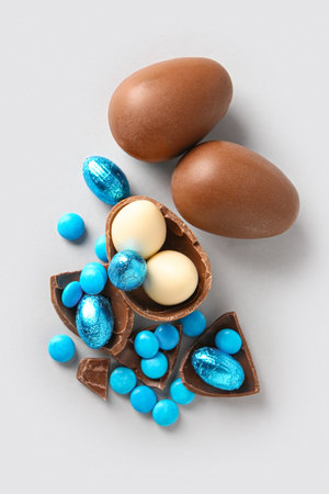 Different chocolate Easter eggs on light background