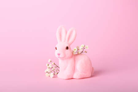 Beautiful Easter bunny and flowers on pink backgroundの写真素材