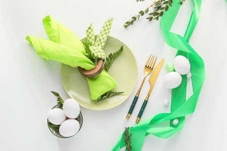 Stylish Easter table setting on white background