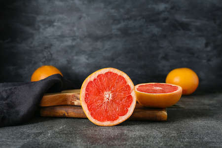 Tasty cut grapefruit on dark backgroundの写真素材