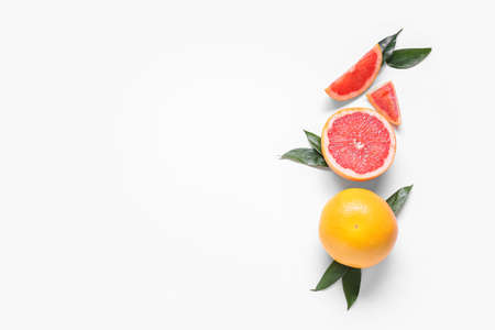 Fresh grapefruit pieces on white backgroundの写真素材