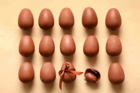 Composition with chocolate Easter eggs on beige background