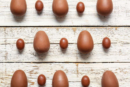 Composition with different chocolate Easter eggs on light wooden backgroundの写真素材