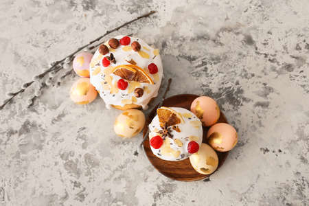 Delicious Easter cakes, pussy willow branches and eggs on beige background