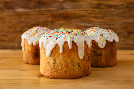 Delicious Easter cakes on wooden background