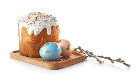 Wooden board with delicious Easter cake, pussy willow branches and eggs on white backgroundの写真素材