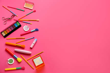 Composition with makeup brushes and cosmetic products on pink backgroundの写真素材